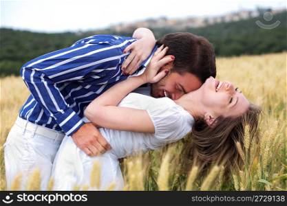 Men and woman hugging in the meadow