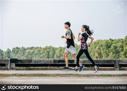 Men and women exercise by running on the road.