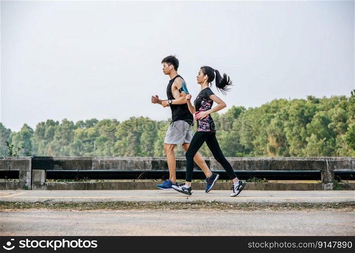Men and women exercise by running on the road.