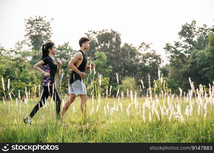 Men and women exercise by running on the streets with trees and flowers.