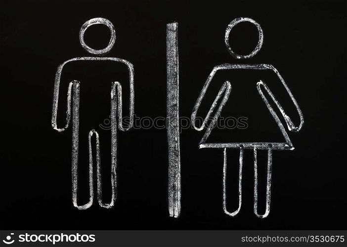 Men and women symbols drawn on a blackboard background