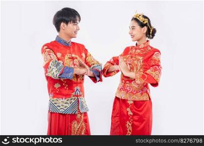 Men and women wear qipao to pay their respects. Isolated on white background