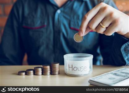 Men are holding coins dropping to the money box with the concept of saving.