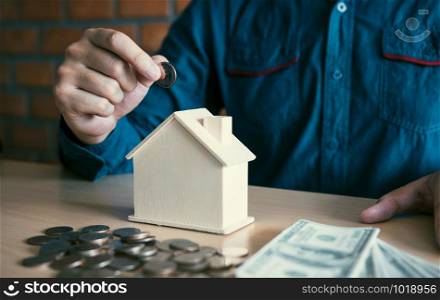 Men are putting coins together with the idea of collecting money to buy a new house.
