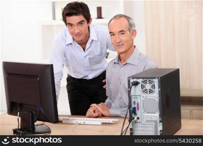 Men behind a computer