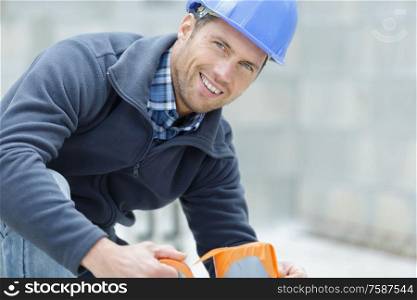 men builder fixing a pipe in a construction