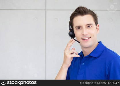Men call-center agent with headset working on support hotline in the office