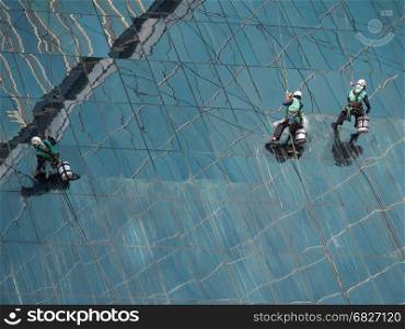 men cleaning glass building