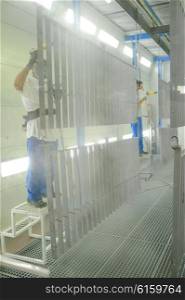 Men cleaning metal grid