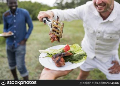 men cooking barbecue outdoors