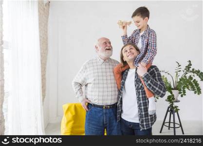men different generations standing together smiling while playing