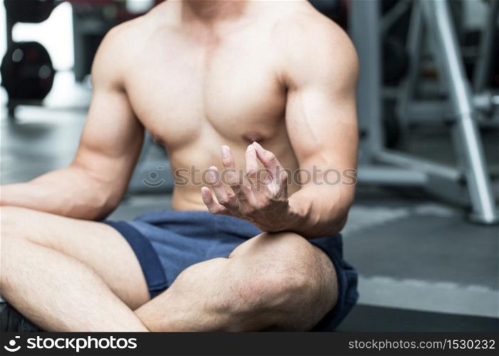 Men doing yoga meditation lotus pose after workout in gym for cool down muscle and relax feeling so strong and happiness,Recreation Concept
