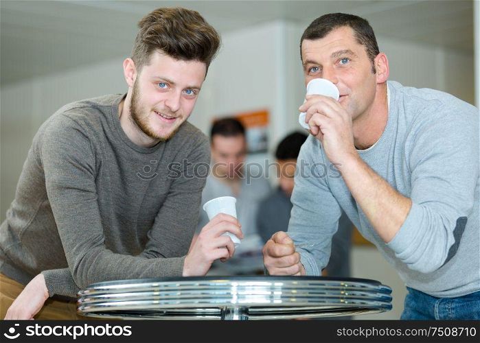men drinking coffee during a break