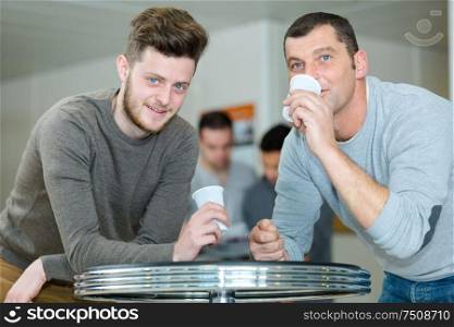 men drinking coffee during a break