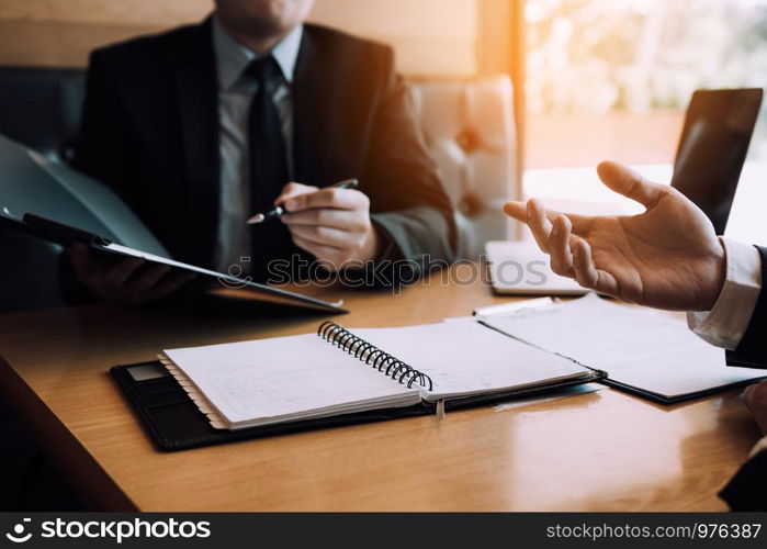 Men employee are describing the employment history of the employer about his work experience.