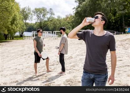 men enjoying drinks holding frisbee