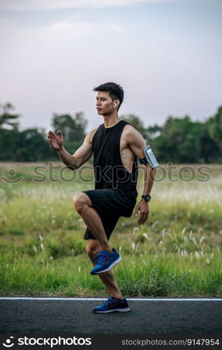 Men exercise by running and lifting their knees forward.