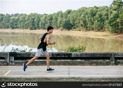 Men exercise by running on the road on the bridge.