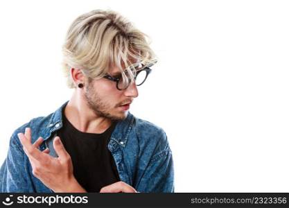 Men fashion, accessories, hairstyle, modeling concept. Artistic hipster man wearing jeans outfit and eccentric glasses looking down, hand gesture, studio shot isolated. Hipster artistic man with eccentric glasses
