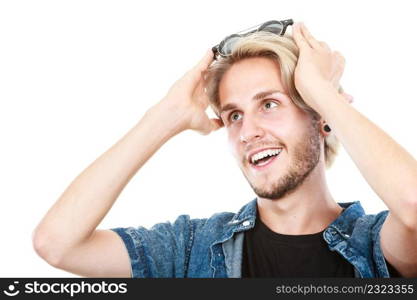 Men fashion, modeling concept. Happy hipster man wearing eccentric glasses on head looking into space studio shot, isolated. Man with glasses on head looking into space
