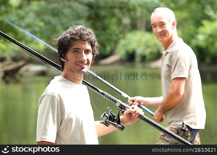 Men fishing at a lake