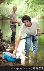 Men fishing in a river