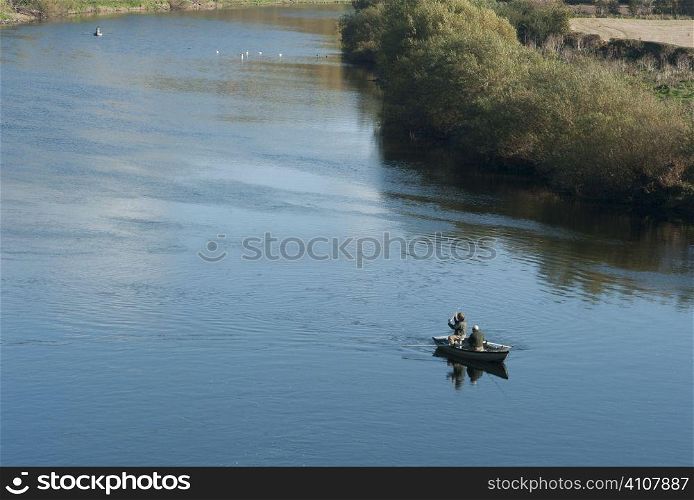 Men fishing in river of Scotland