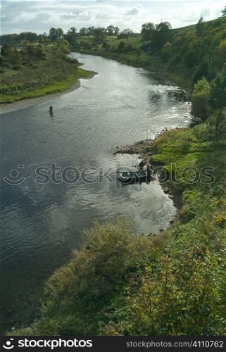 Men fishing in river of Scotland