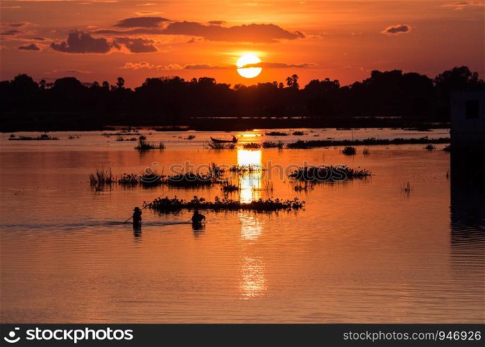 Men fishing on the Lake at sunset scene in Mandalay, Myanmar
