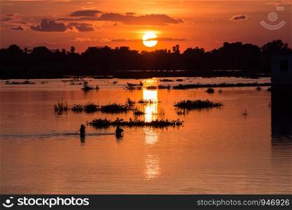 Men fishing on the Lake at sunset scene in Mandalay, Myanmar