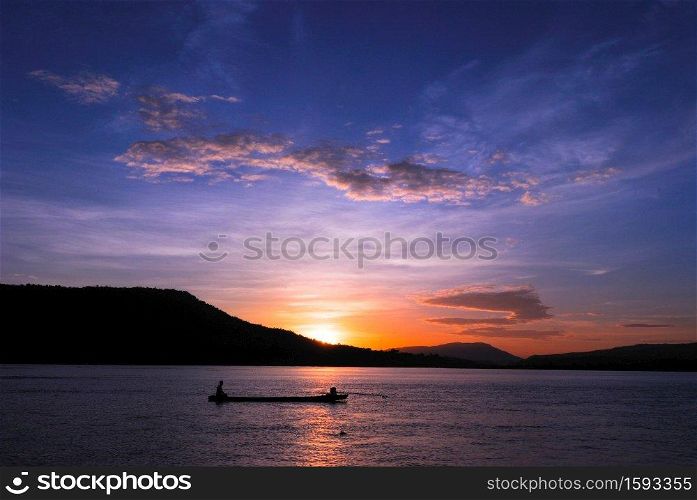 Men fishing on the Mekong River in a field at sunset