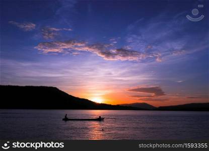 Men fishing on the Mekong River in a field at sunset