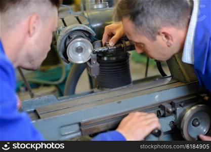 men fixing machine