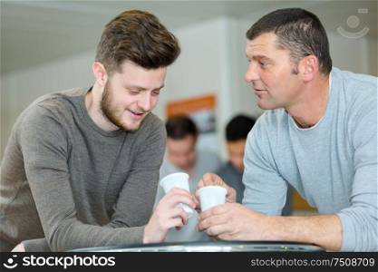 men having a cup of coffee together