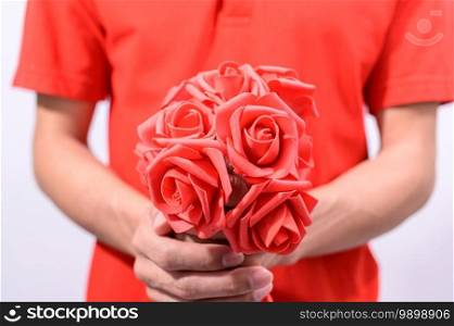 Men hold a bouquet of roses on valentine’s day