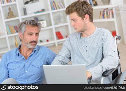 men in front of a laptop