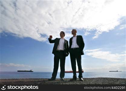 Men in suit chatting at the seaside