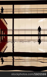 men in the modern building, with reflection