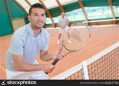 men in the tennis court