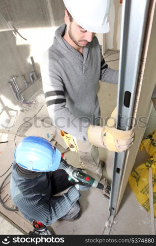 Men installing wall panel
