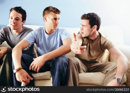 Men joking around on sofa