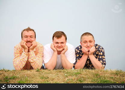 men laying on the grass