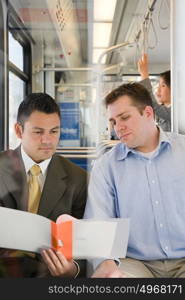 Men looking at file on train
