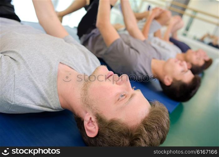 men lying on the mats