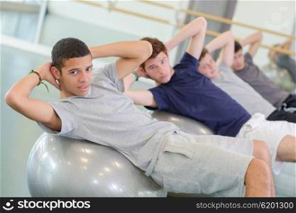 men on top of gym ball