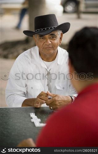 Men playing dominos, outdoors