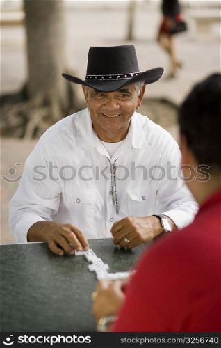 Men playing dominos, outdoors