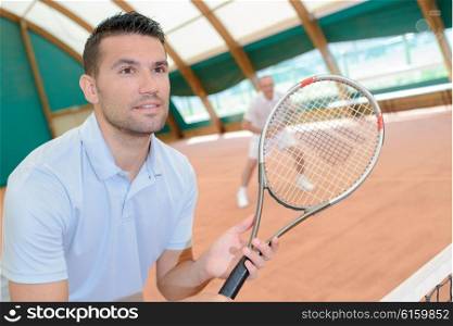 Men playing tennis match