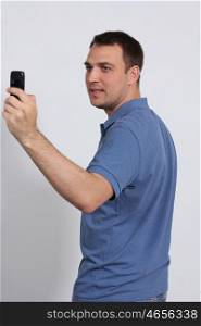 Men posing for a photograph taken from his cell phone