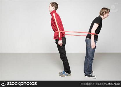 Men pulling plastic hoop
